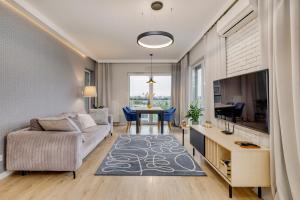 a living room with a couch and a table at Sen Krasnala by FuzjaAparts in Wrocław