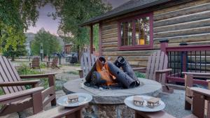 a fire pit in front of a log cabin at Harris House in Breckenridge