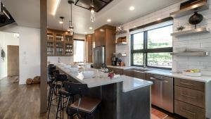a large kitchen with a large island in the middle at Hilltop Chateau in Steamboat Springs