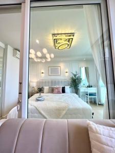 a bedroom with a bed and a large mirror at icondo มิตรภาพซอย4 in Nakhon Ratchasima +19 photos