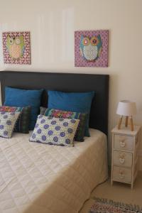a bedroom with a bed with two pillows and a night stand at Cabanas Apartment in Tavira +172 photos