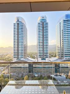 a view of three tall buildings in a city at Elysium Premium Centaurus View in Islamabad