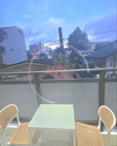 a white table and two chairs on a balcony at Megatower 3 GF17 Baguio Condo by Dei Gratia in Baguio