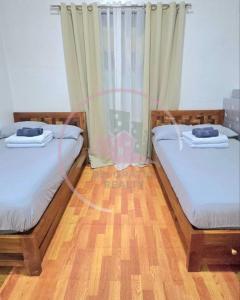 two beds sitting next to each other in a room at Megatower 3 GF17 Baguio Condo by Dei Gratia in Baguio