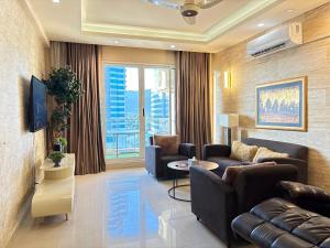 a living room with two couches and a tv at Elysium Premium Centaurus View in Islamabad