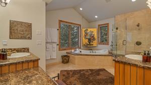 a large bathroom with two sinks and a tub at Inglenook in Breckenridge
