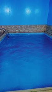 a large blue swimming pool with blue water at منتجع سيتي لاند فله رقم 4 in Taif +10 photos