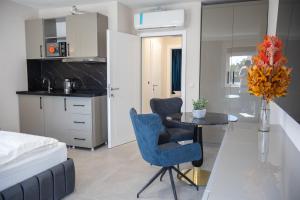 a kitchen and a bedroom with a table and a bed at Deluxe Apartment in Bonn