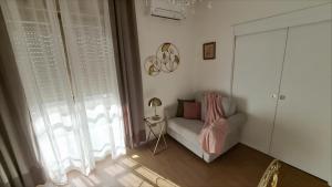 a living room with a couch and a window at La perla di Caserta 2 in Caserta