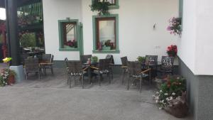 a patio with chairs and tables in a restaurant at Mama's House 7min from Airport in Cerklje na Gorenjskem
