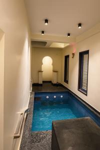a swimming pool in the middle of a house at 4 BHK Villa with Pool steam bath jacuzzi in jaipur in Jaipur