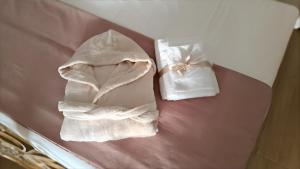 a pair of white towels sitting on top of a bed at La perla di Caserta 2 in Caserta