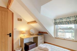 a bedroom with a bed and a window at 2 Bed in Ponthirwaun oc-h33292 in Pont Hirwaun