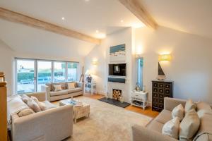 a living room with two couches and a fireplace at 5 Bed in Rock oc-m33185 in Padstow