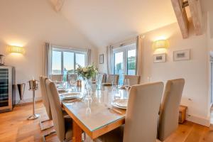 a dining room with a long table and chairs at 5 Bed in Rock oc-m33185 in Padstow