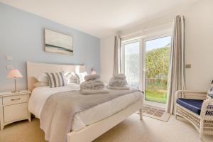a bedroom with a bed with towels on it at 5 Bed in Rock oc-m33185 in Padstow +40 photos