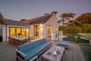 a patio with a blue couch and a table at 5 Bed in Rock oc-m33185 in Padstow