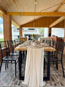 a wooden table with chairs around it in a room at Cabana 1407 Valea Avrigului in Avrig