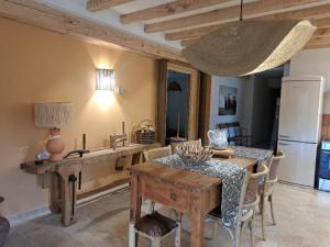 a kitchen and dining room with a table and a dining room at La Clef des songes in Lafarre +10 photos