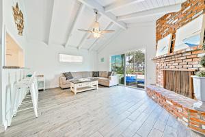 a living room with a brick fireplace and a couch at Balboa Duplex in Newport Beach