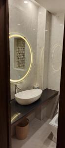a bathroom with a sink and a mirror at 2 bed Stylish Furnished Apartments at Prime Location in Lahore