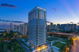 a tall building in the middle of a city at Fairfield by Marriott Wuhan Hankou in Wuhan