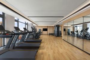 a gym with treadmills and elliptical machines at Fairfield by Marriott Wuhan Hankou in Wuhan
