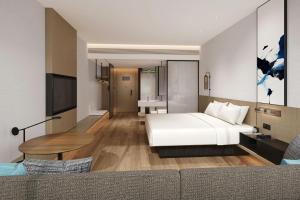 a hotel room with a bed and a table at Fairfield by Marriott Yinchuan Xingqing in Yinchuan