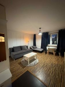 a living room with a couch and a table at City Vibes Warsaw Sienna by P&M in Warsaw