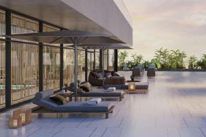 a lobby with couches and umbrellas on a building at JW Marriott Hotel Tashkent in Tashkent