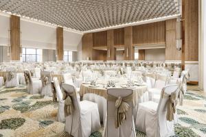 a banquet hall with white tables and chairs at JW Marriott Hotel Tashkent in Tashkent