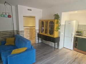 a living room with a blue couch and a refrigerator at Zeljka in Zagarolo