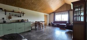 a kitchen and living room with a couch and a table at MagnaFrisia in Gauw