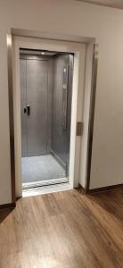 a glass door to a shower in a room at Charming Room in a Central Location with perfect Connectivity in Munich +13 photos