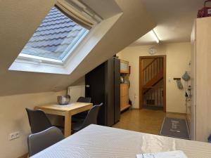 an attic room with a table and a window at Ferienhaus mit Weitblick bei Medebach in Medebach +31 photos