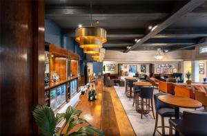 a restaurant with tables and chairs and a bar at Thatchers, Leatherhead East Horsley in East Horsley +100 photos