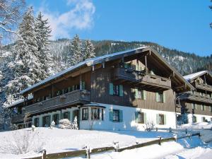 贝里斯泽尔Lush apartment in Bayrischzell with 2 saunas的大型滑雪小屋,地面上积雪