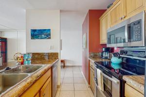 a kitchen with a sink and a stove top oven at Kona Reef Comfort D6 in Kailua-Kona +23 photos