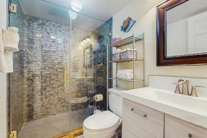 a bathroom with a shower and a toilet and a sink at Kona Reef Comfort D6 in Kailua-Kona
