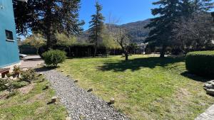 a garden with some rocks in the grass at Casa Yuco Hostel in San Martín de los Andes