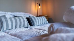 a white couch with striped pillows in a room at Finca del Campito in Villa Berna