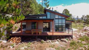 a house on the side of a hill with trees at Finca del Campito in Villa Berna