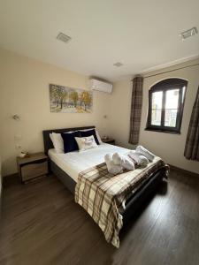 a bedroom with a large bed and a window at Apartment Zdravets 2, in the heart of the old city in Veliko Tŭrnovo