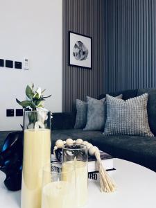 a living room with a couch and a table at Modern Apartment 2 in Jeddah