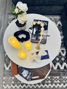 a white table with a plate with a vase of flowers at Modern Apartment 2 in Jeddah