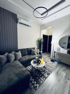 a living room with a couch and a table at Modern Apartment 2 in Jeddah +25 photos