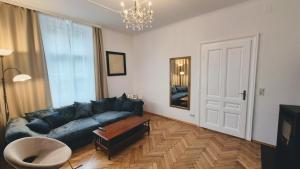 a living room with a couch and a table at Villa Ohrenstein - Komfort Suite in Bad Ischl