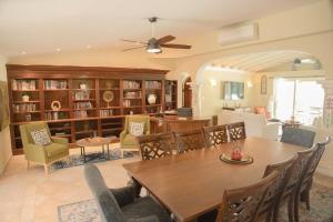 ein Esszimmer mit Tisch und Stühlen und eine Bibliothek in der Unterkunft Villa Marrakesh, Cupecoy Beach - A Luxury Villa with Pool in Lowlands