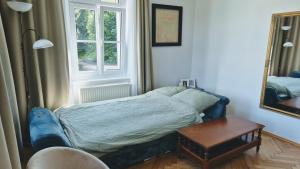 a bedroom with a bed and a table and a mirror at Villa Ohrenstein - Komfort Suite in Bad Ischl