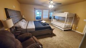 a bedroom with a bunk bed and a couch at Lodge One with Scenic View in McKinney